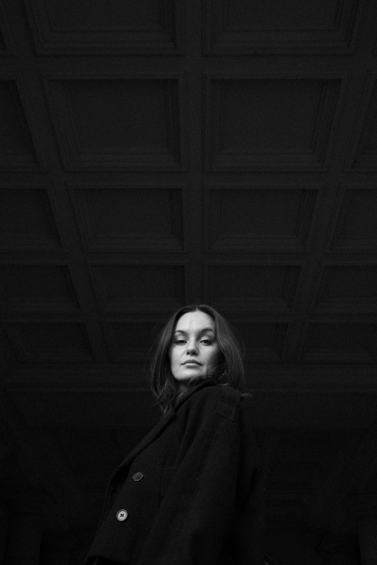 Helena Wedekind low in the frame beneath a coffered ceiling