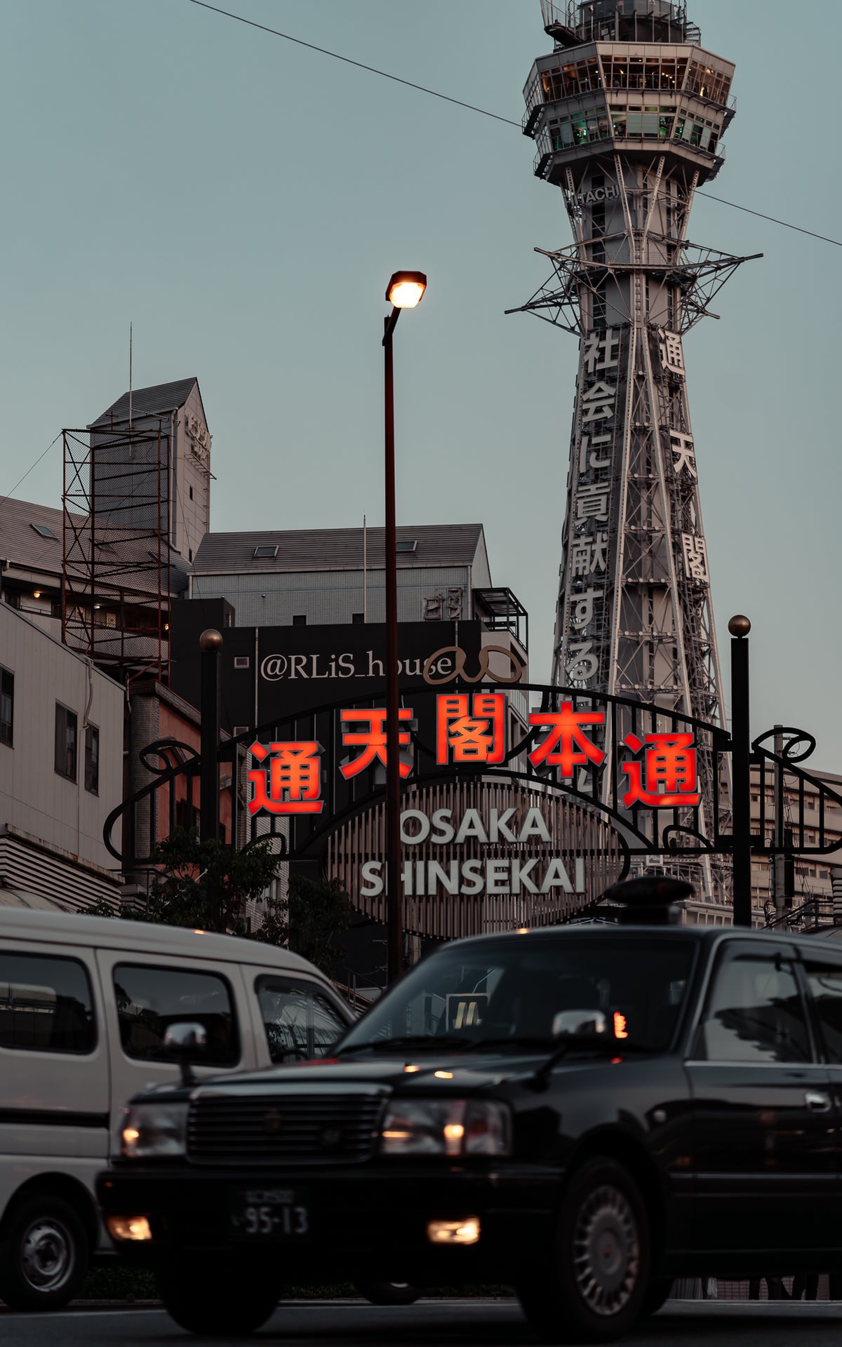 Taxi below the neon gate at Shinsekai, Osaka