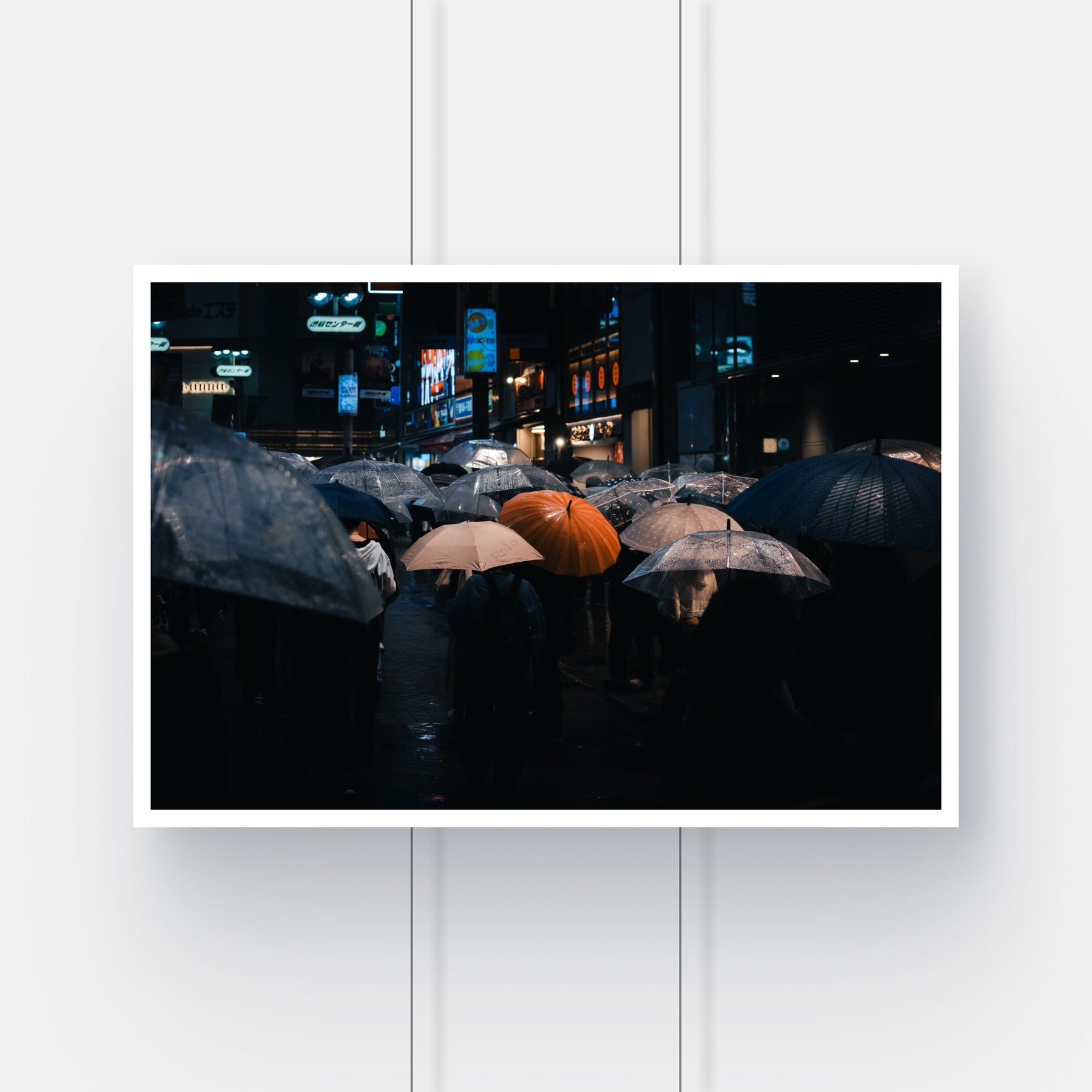 Limited edition street photography print of a person with an orange umbrella in the rain in Shibuya, Tokyo.